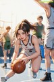 A girl dribbling a basketball on a basketball court.