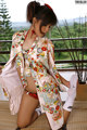 A woman in a kimono is posing for a picture.