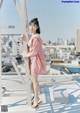 A woman standing on top of a building next to a ladder.