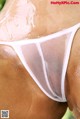 A close up of a woman in a white thong.